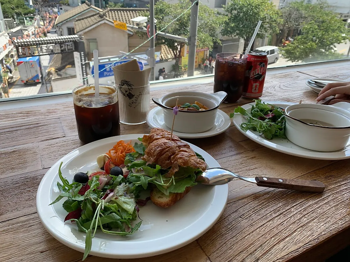 Brunch table beside the floor-to-ceiling windows at Wine Stein Seochon