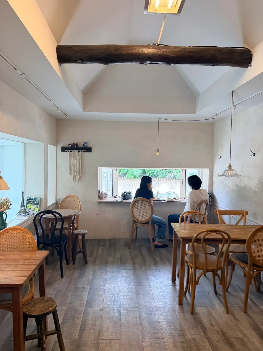 Second-floor window seat with a view of tiled roofs