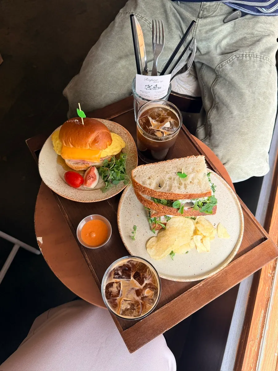 Two sandwich plates and an americano served together