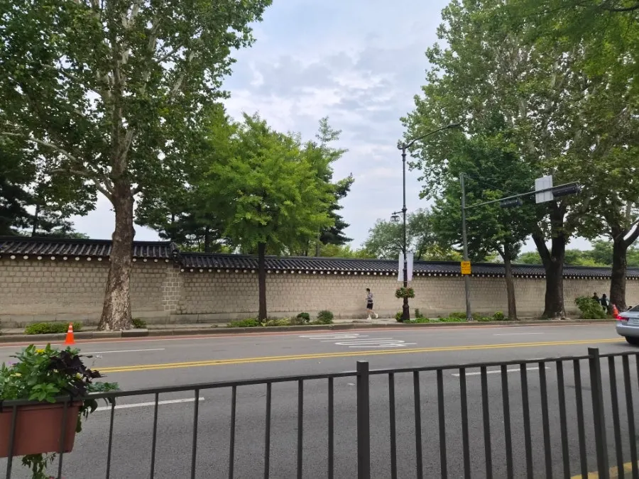 Walking up along the Gyeongbokgung Palace stone wall path