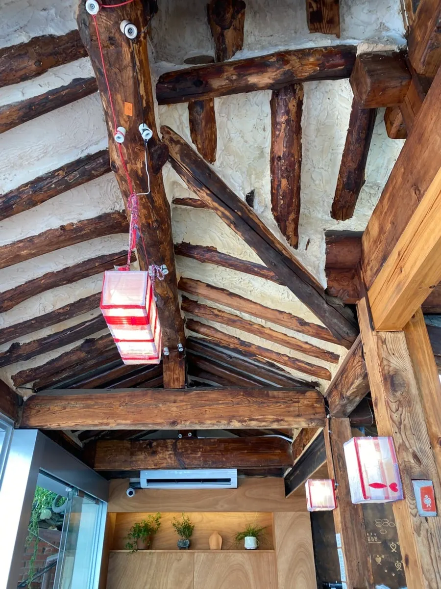 Hanok wooden rafter ceiling with red fabric lighting