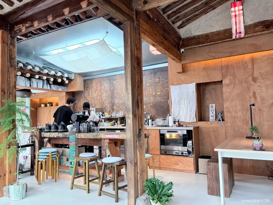 Hanok café interior with paper lanterns and plants