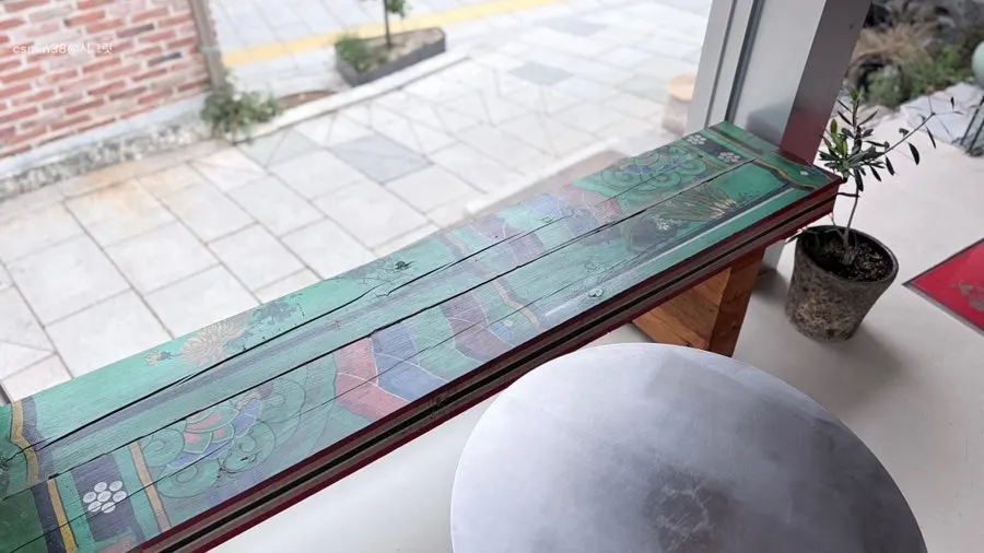 Close-up of the bench wood with faded dancheong color