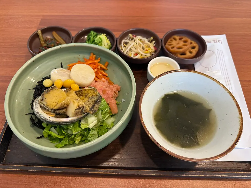 Jeju tot bap topped with abalone and scallop