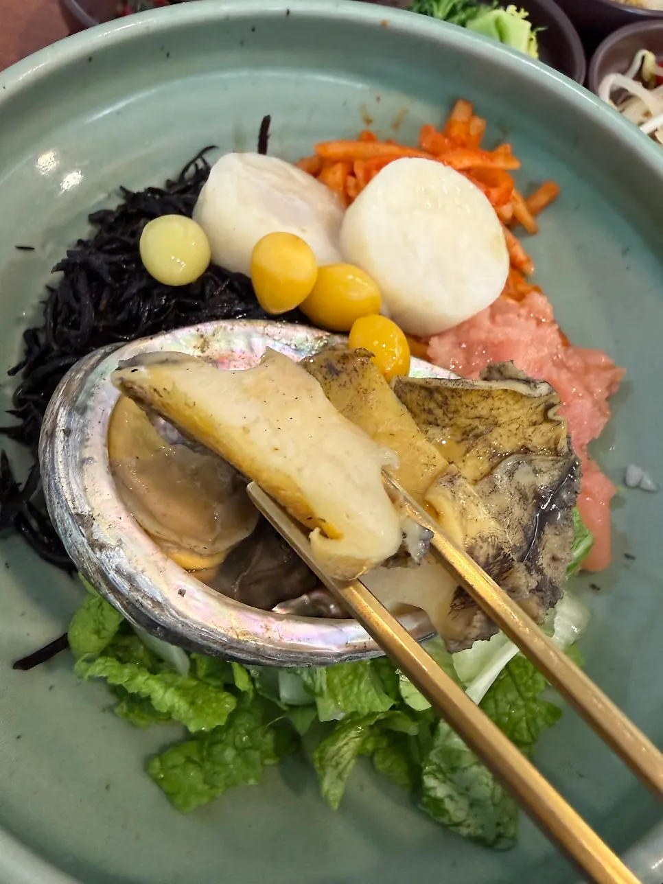 A bite of the tot bap with abalone and scallop