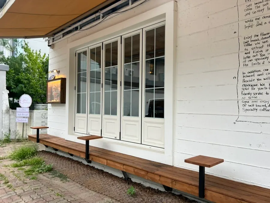 Outdoor tables and chairs on the left side of the shop