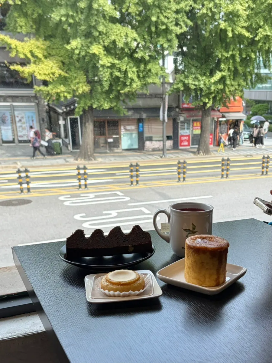 Desserts and drink on a window-side table