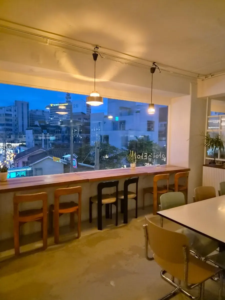 Window bar table and floor-to-ceiling window seating at Wine Stein