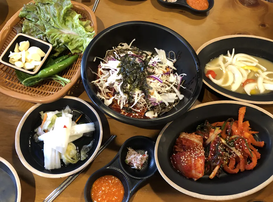 Basic table setting with wrap vegetables and three types of kimchi