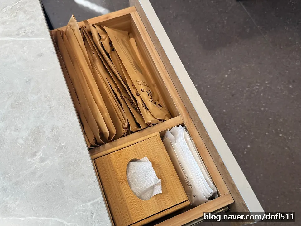 Utensils wrapped in a paper sleeve alongside salt and pepper