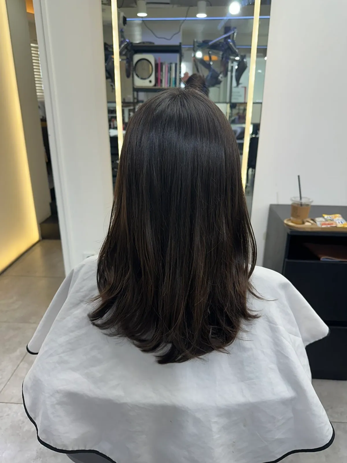 Finished medium-length style with a natural C-curl