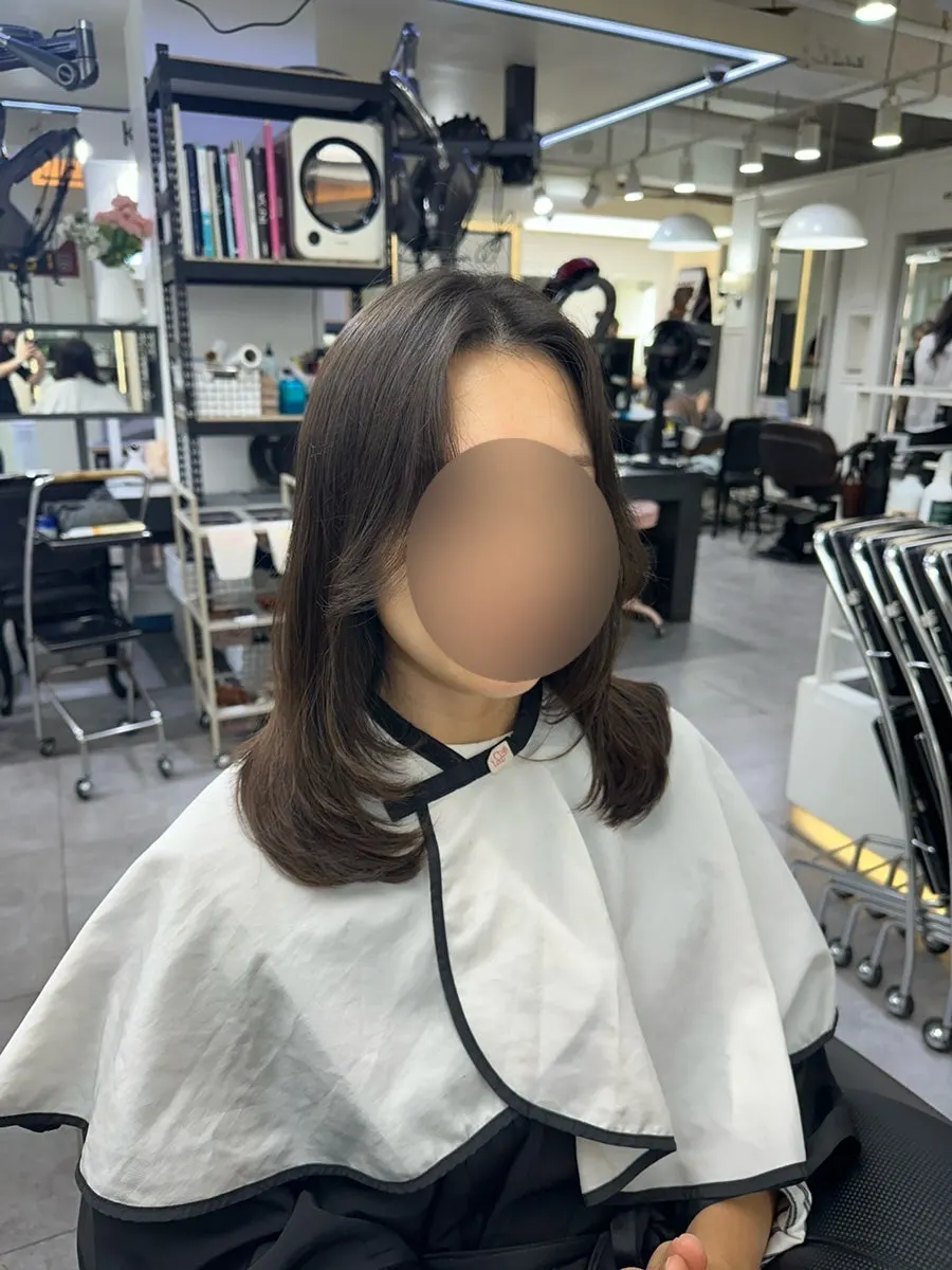 Back view of the finished medium-length layered C-curl perm