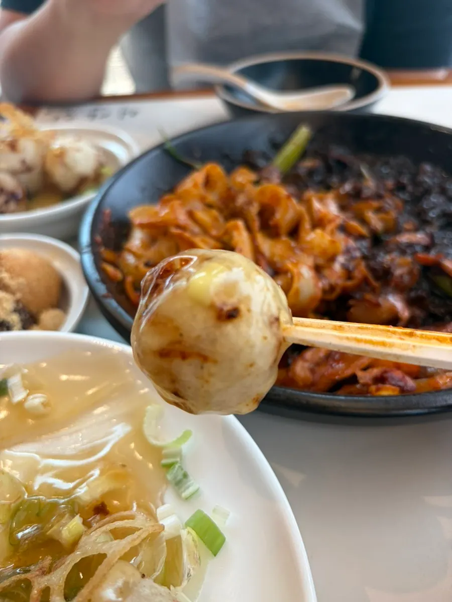 A piece of tangsuyuk with sweet and tangy sauce