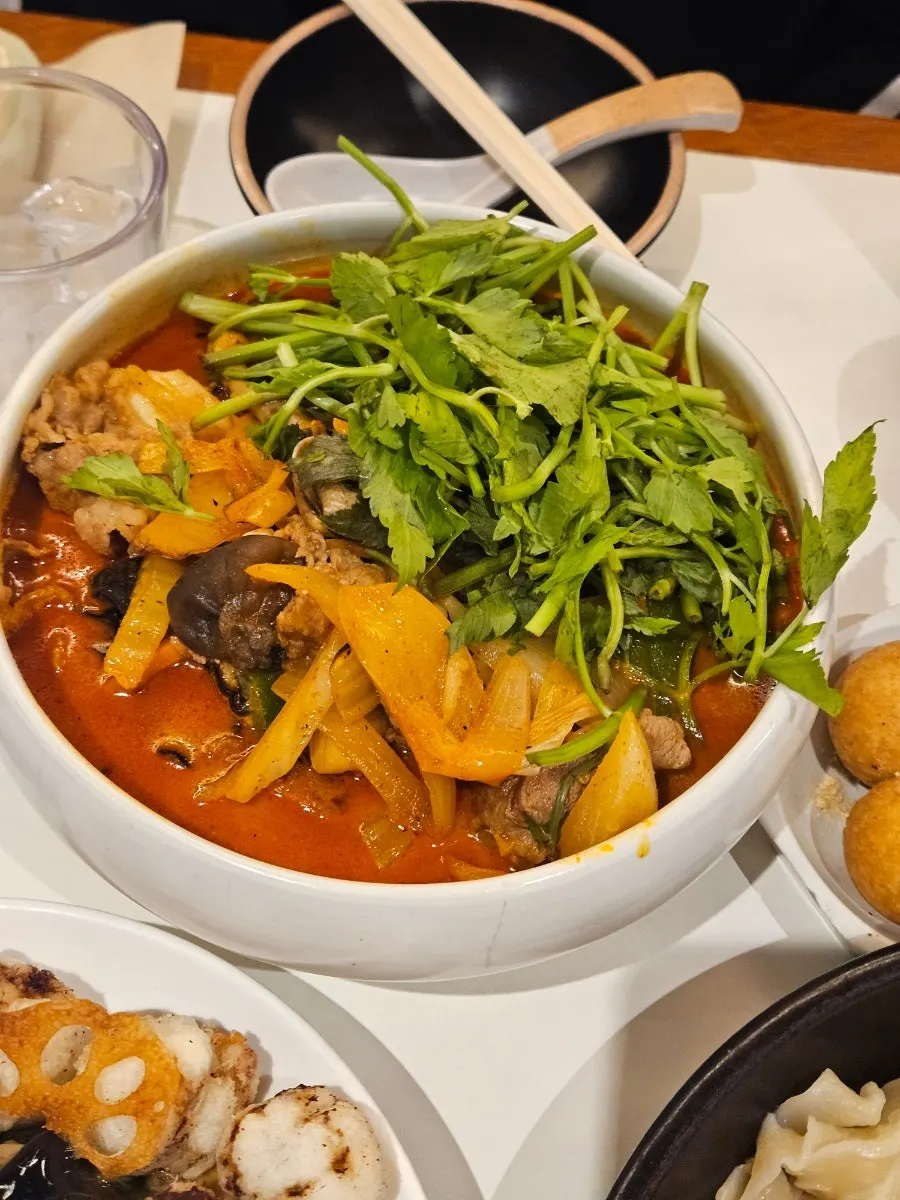 A bowl of minari usamgyeop jjamppong topped with minari