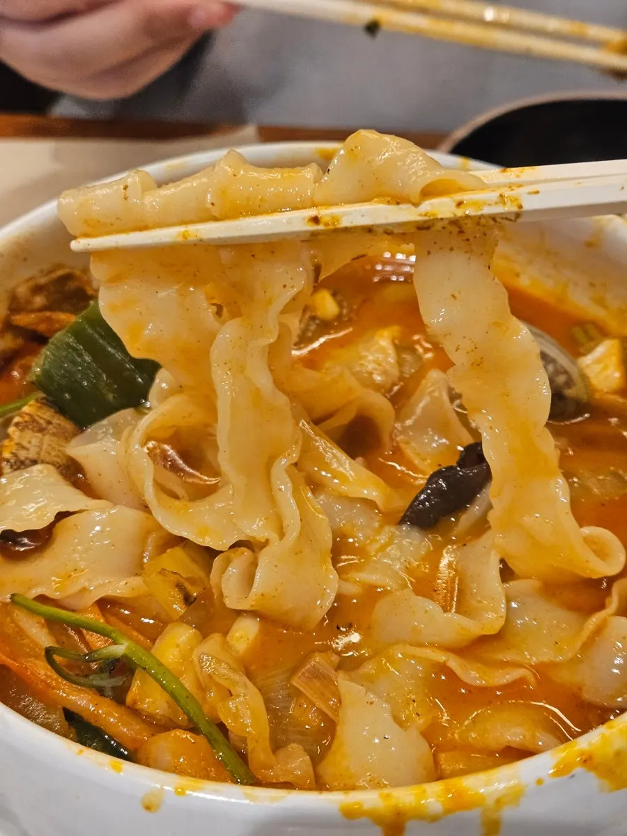Close-up of the minari usamgyeop jjamppong broth and beef brisket