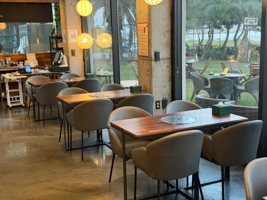 Spaciously spaced tables inside Jeju Healing Dwaeji