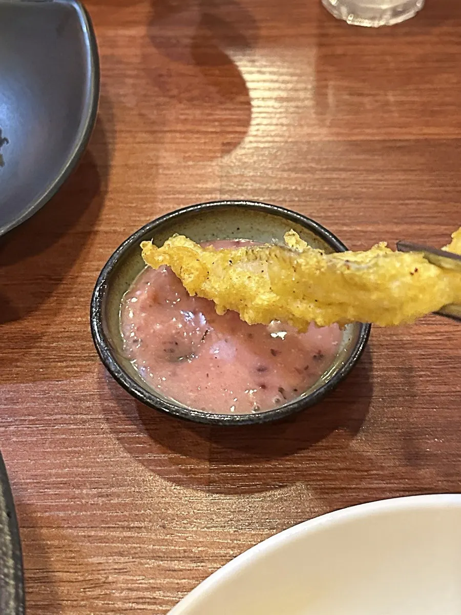 Cross-section of fried cutlassfish dipped in sauce