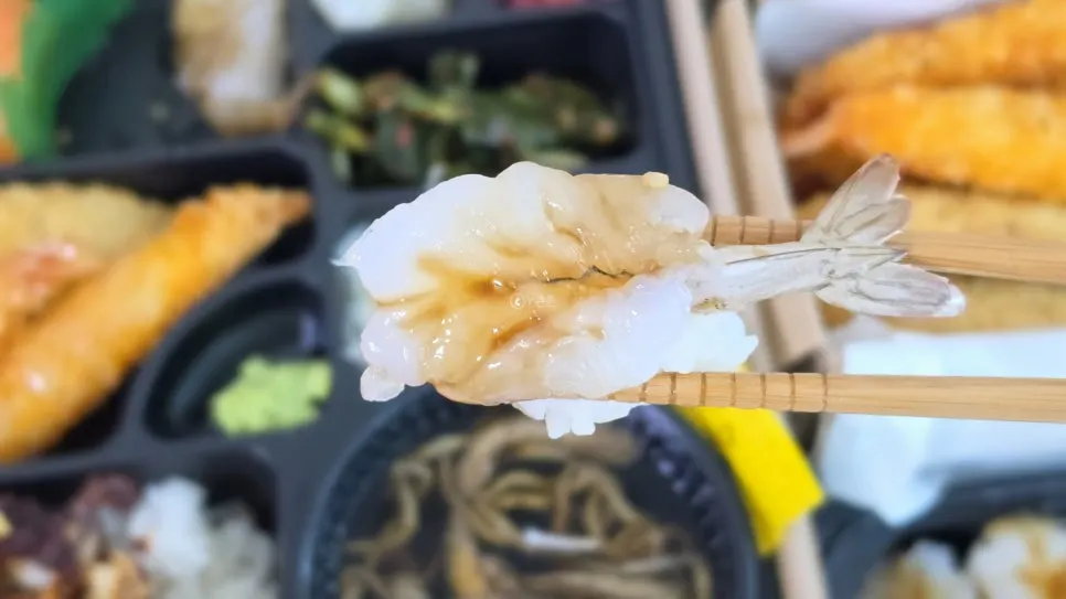 Salmon sushi topped with onion sauce