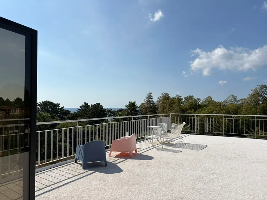 View of the Seogwipo sea through the 2nd floor floor-to-ceiling windows