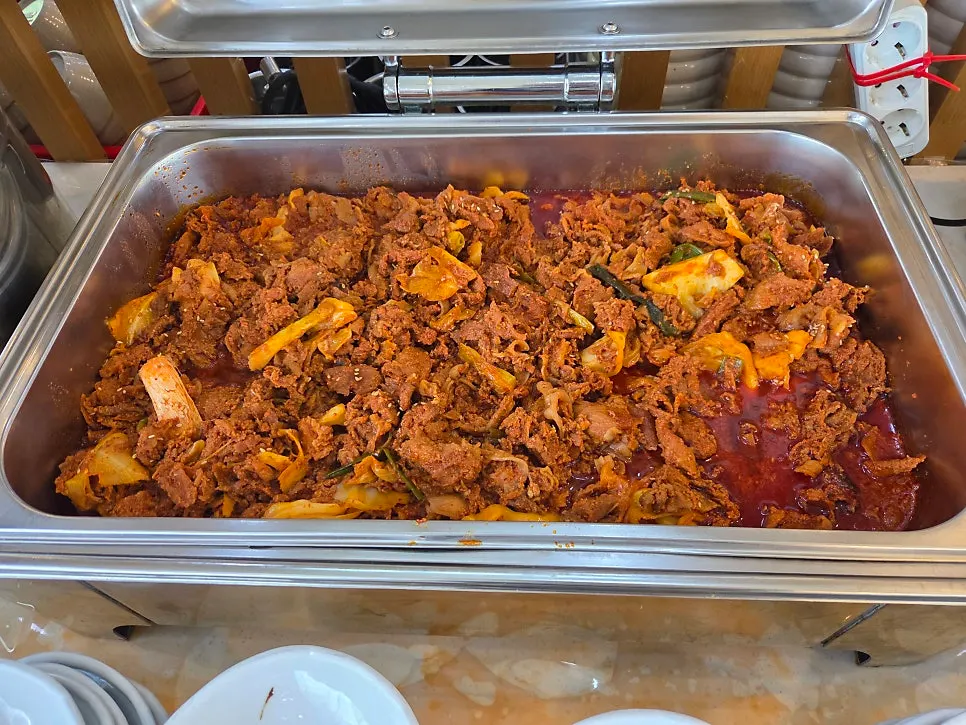 Warm self-serve bar with japchae and spicy stir-fried pork