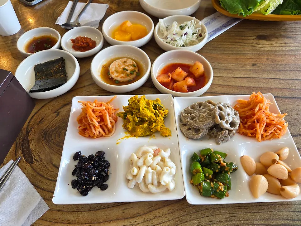Self-serve side dishes including braised black beans and macaroni salad