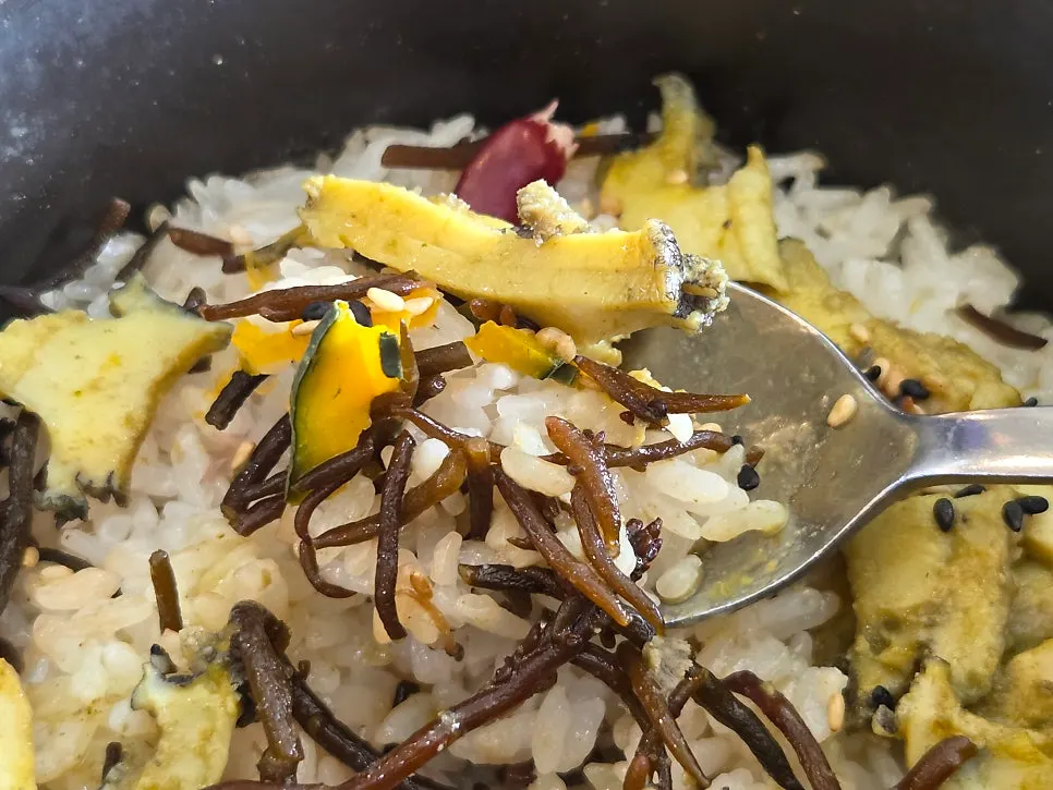 Table spread of braised mackerel and abalone stone-pot rice