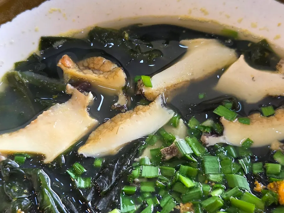 Spoonful of abalone and seaweed from the seaweed soup