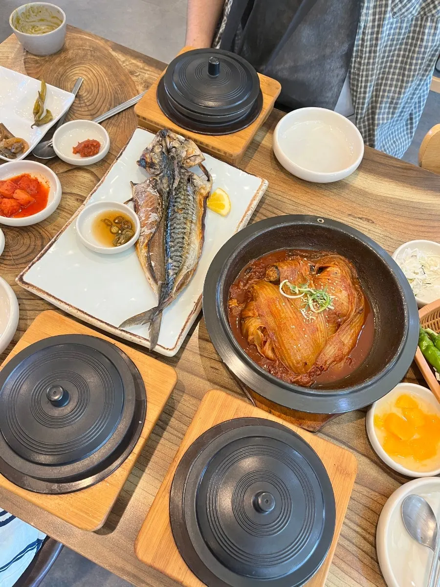 Abalone stone-pot rice and mackerel ssam-bap table setting