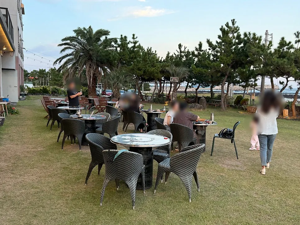 Outdoor table at Jeju Healing Dwaeji with ocean view