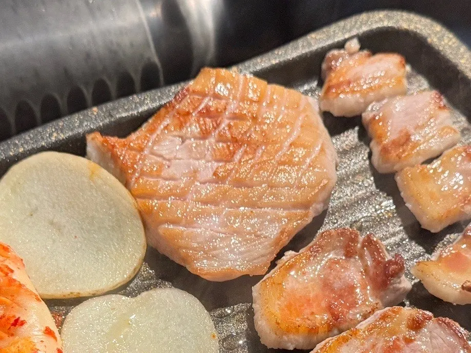 Pork belly cooking on the grill