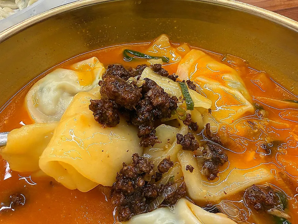 Inside the bowl with sujebi, dumplings and minced meat