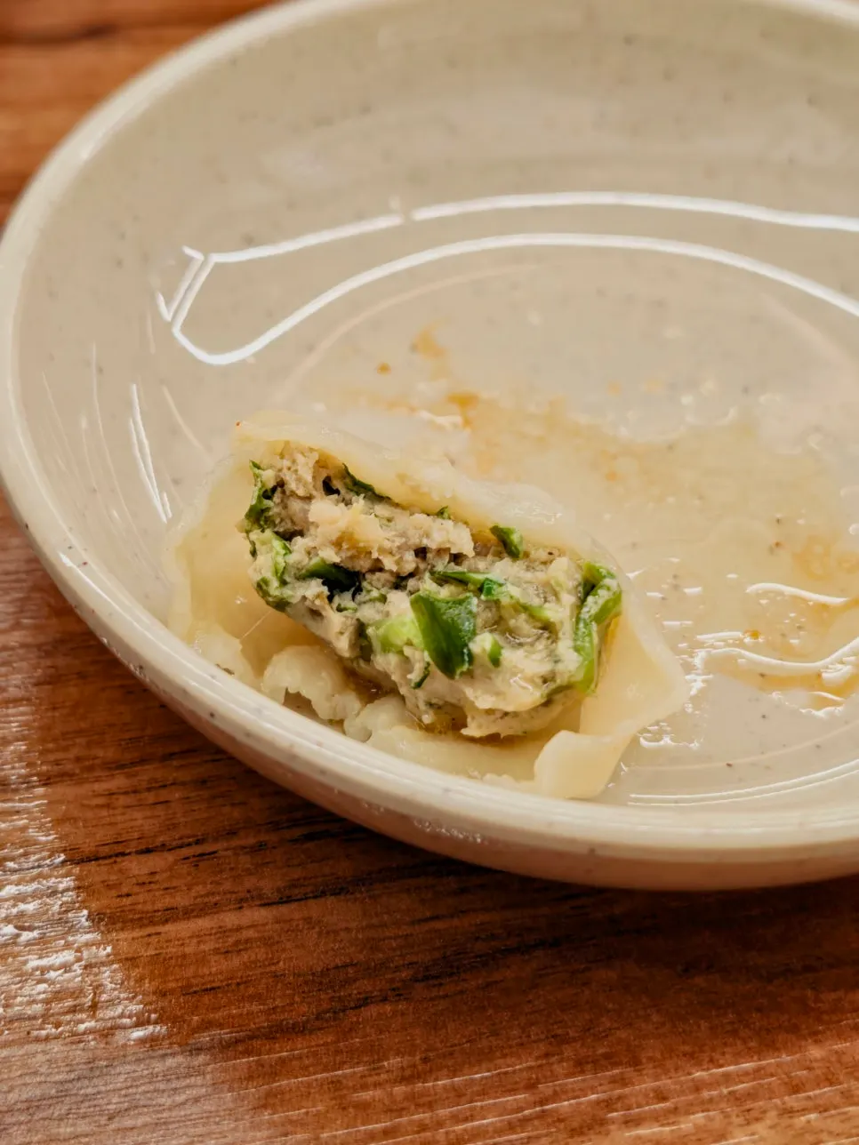 Adding gyoza dumplings into the kalguksu