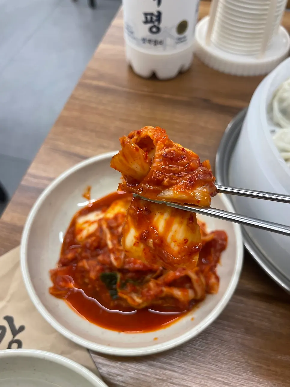 Kalguksu-restaurant kimchi with a glass of makgeolli