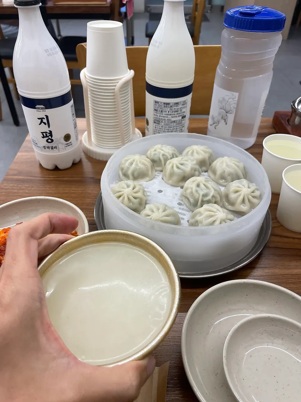 A solo dinner table set with dumplings and sujebi
