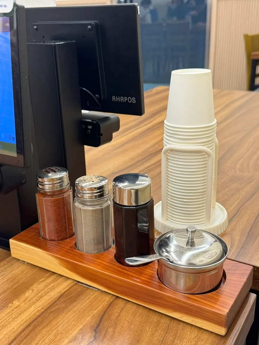 Red pepper flakes and seasoning sauces neatly arranged on the table