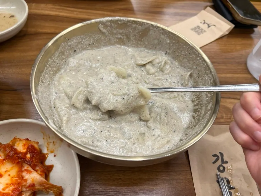 Tteokgalbi placed alongside the kalguksu on the table