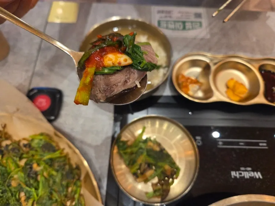 Table spread with the boiled pork hot pot