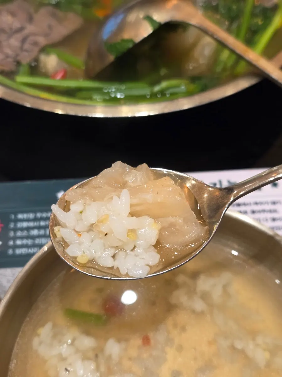 Hot pot ingredients scooped up with a ladle