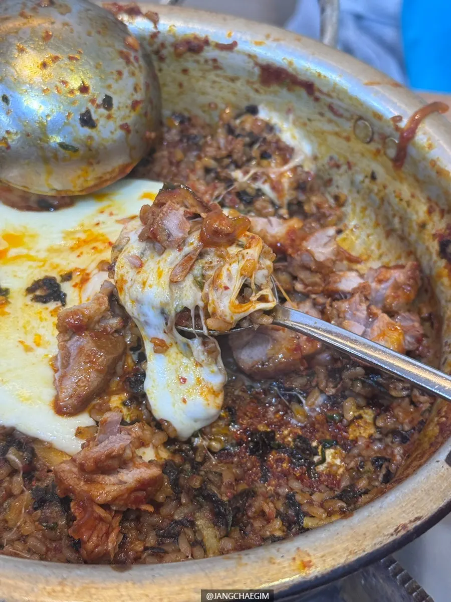 Fried rice crisping on the pan with melted cheese