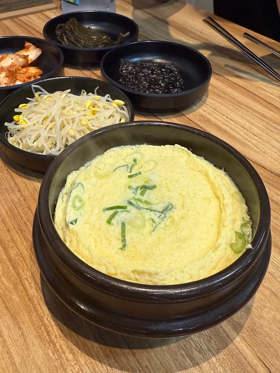Stone pot egg custard and side dishes on the table