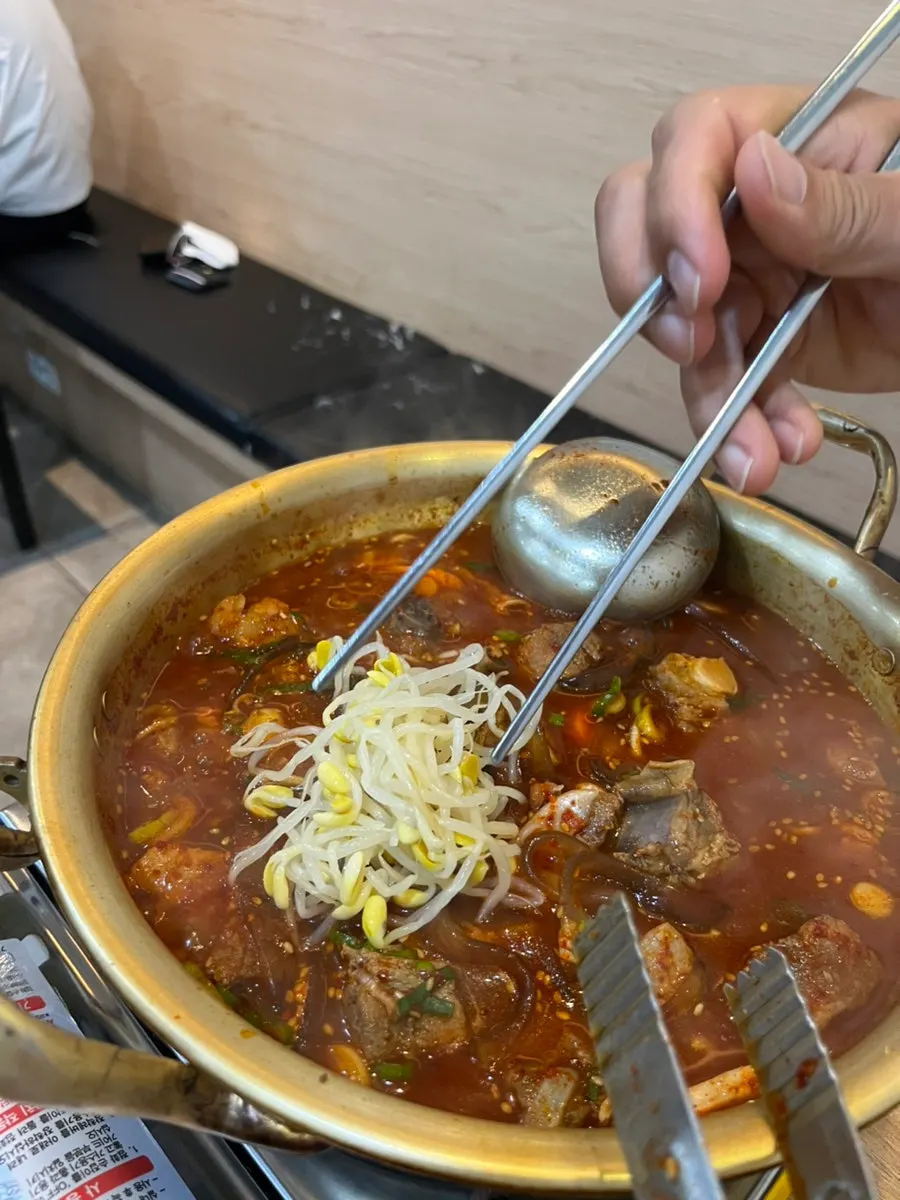 Eating the spicy galbijjim together with rice