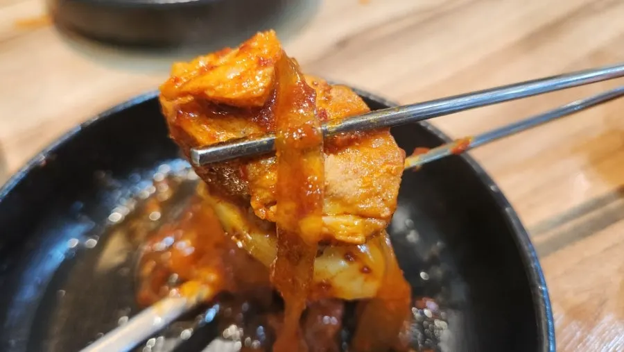 A piece of pork rib coated in sauce