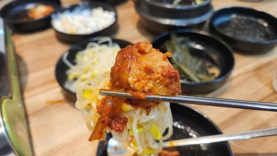 Pork galbijjim placed on top of bean sprouts