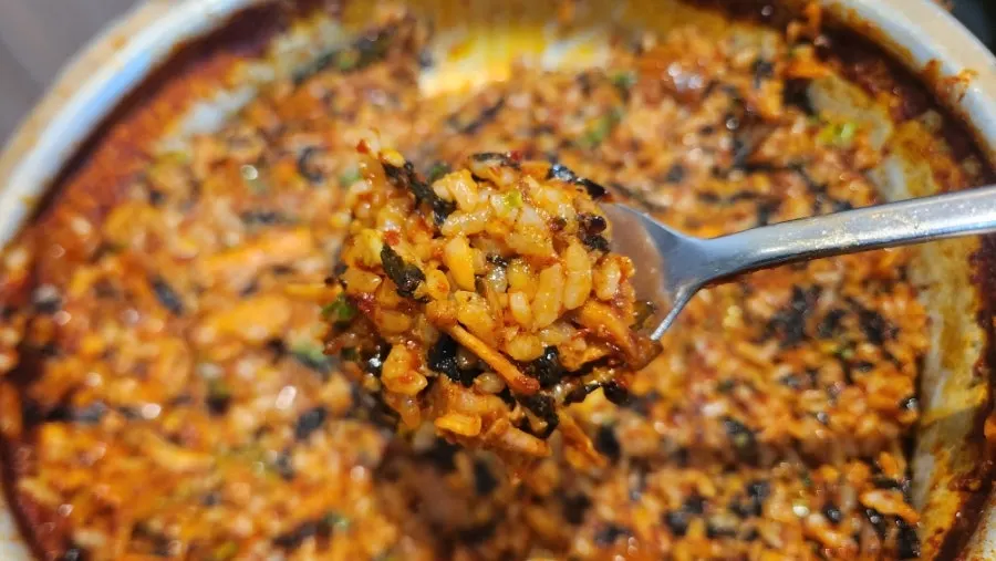 A large spoonful of fried rice scooped up