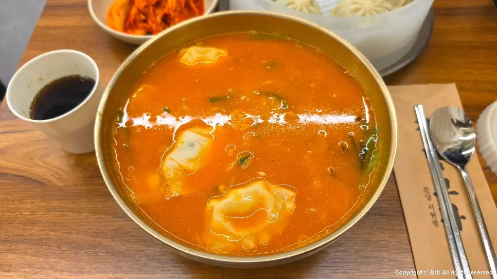 A bowl of spicy sujebi with a fiery broth