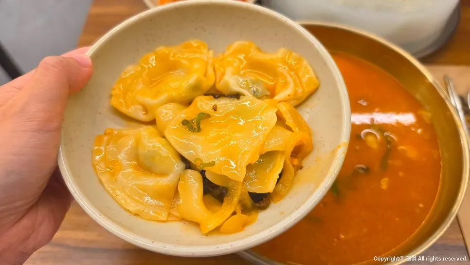 Close-up of chewy sujebi and dumplings in spicy broth