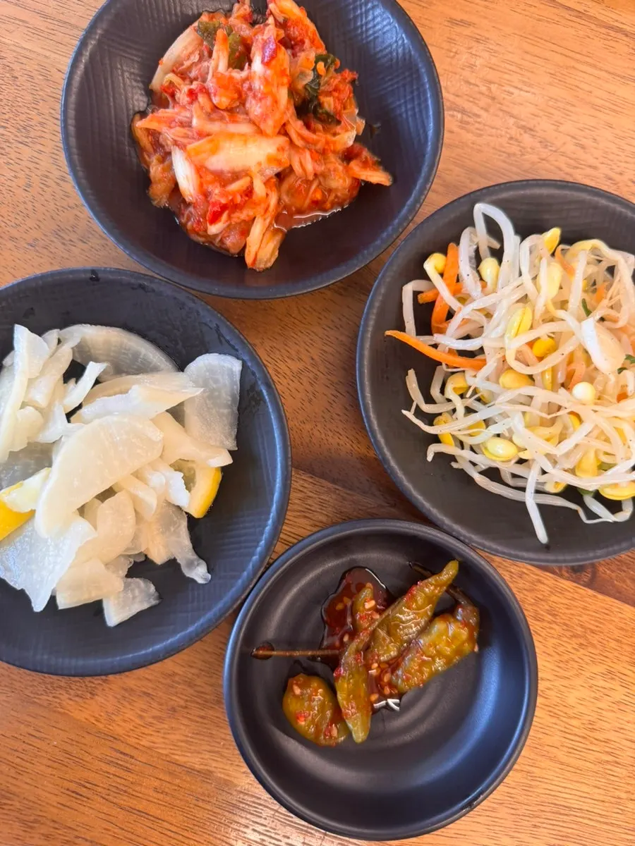Full table view with side dishes and soup