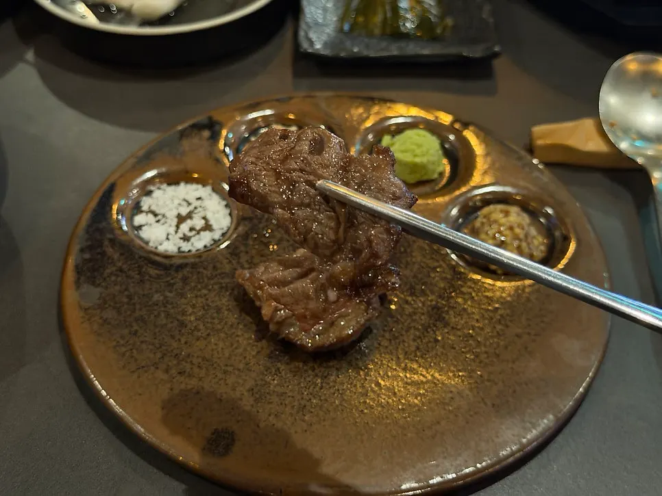 Well-marbled beef grilling over charcoal