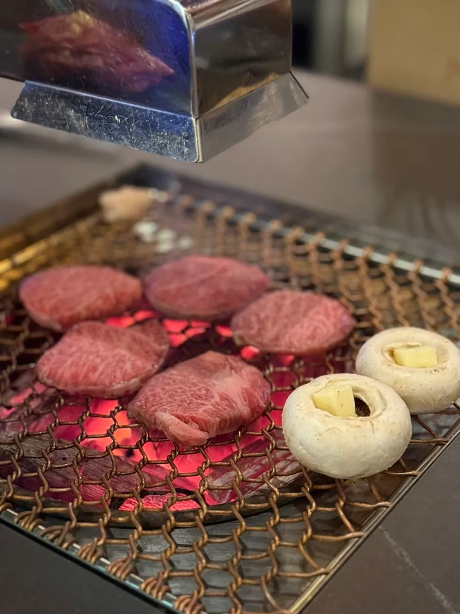 Charcoal-grilled beef with a glass of wine
