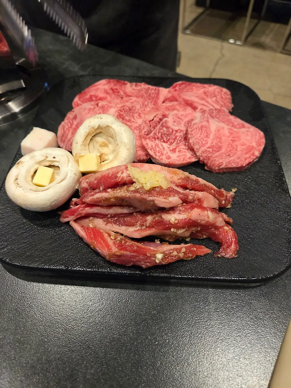 Side dishes for hanwoo including mountain garlic leaves and sliced green onion